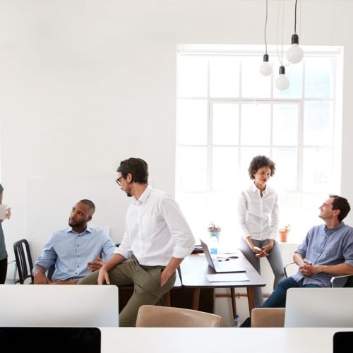 Young,Business,Group,In,Discussion,In,Their,Office